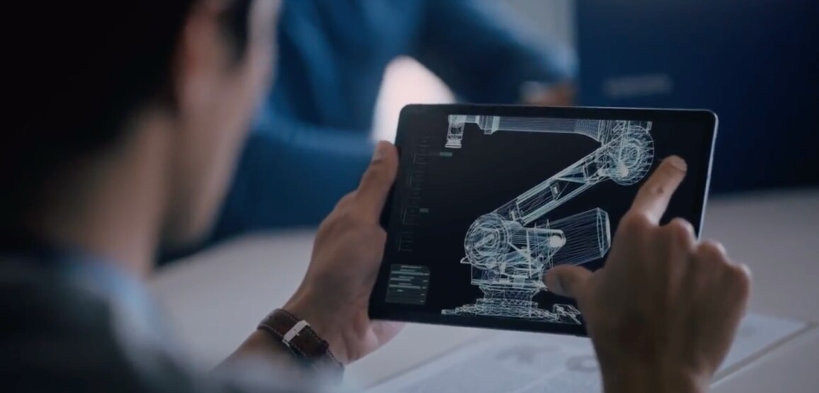 The man is enlarging the image he is looking at on a tablet.